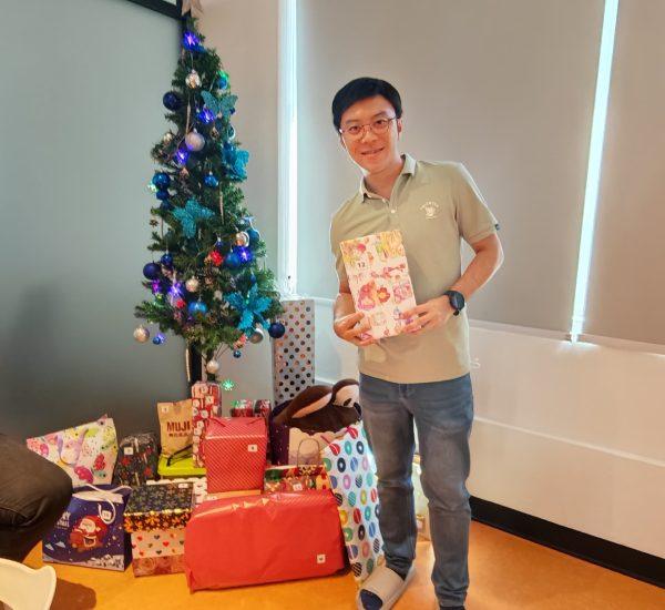 A guy happily posing when getting his christmas gift