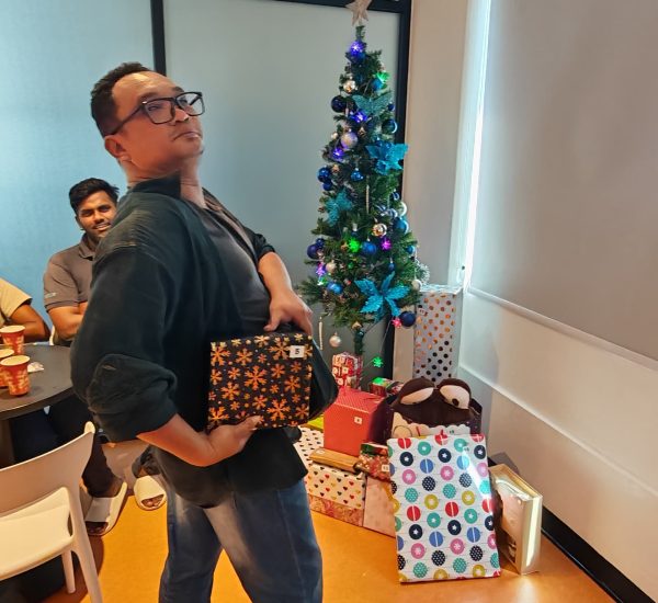 man posing while getting his christmas gift