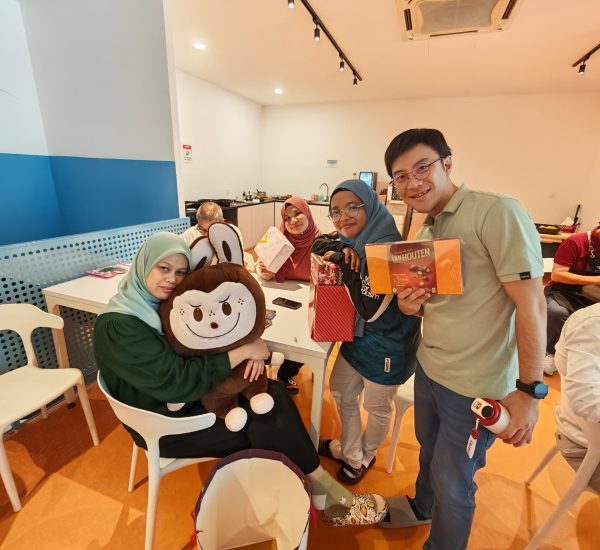 team posing with their christmas gift
